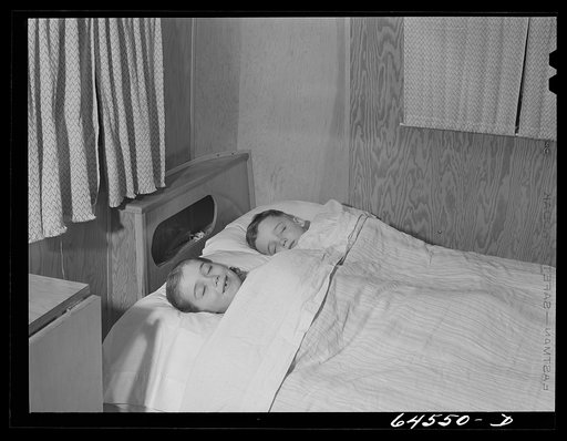 Untitled photo, possibly related to: Burlington, Iowa. Acres unit, FSA (Farm Security Administration) trailer camp. Cecil Patrick's kids in bed in their trailer for workers at Burlington ordnance plant