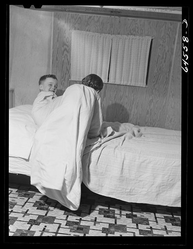 Untitled photo, possibly related to: Burlington, Iowa. Acres unit, FSA (Farm Security Administration) trailer camp. Cecil Patrick's kids going to bed in their trailer for workers at Burlington ordnance plant