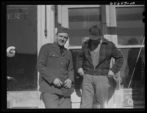 Bowdle, South Dakota. Soldier home on furlough, talking with friend in front of pool hall