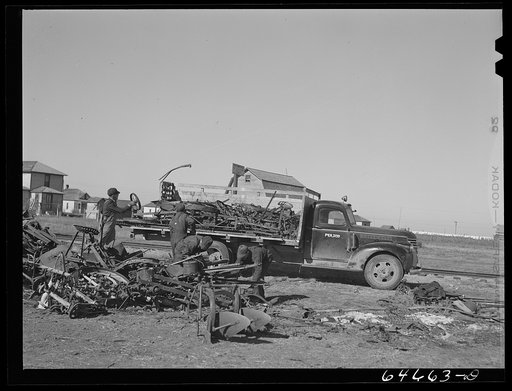 Untitled photo, possibly related to: Northville, South Dakota. Loading scrap iron onto truck