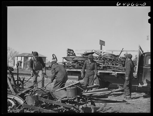 Northville, South Dakota. Loading scrap iron onto truck