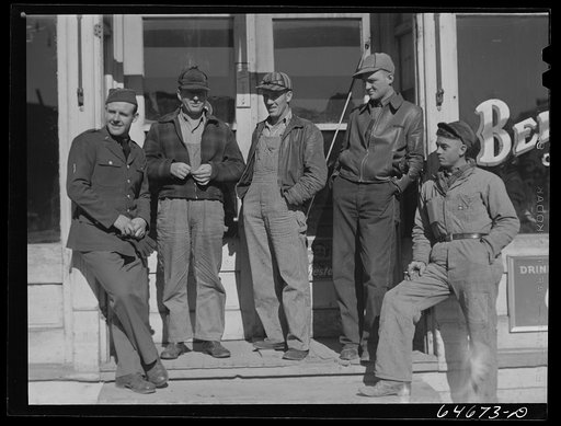 Bowdle, South Dakota. Soldier on furlough with friends in front of pool hall