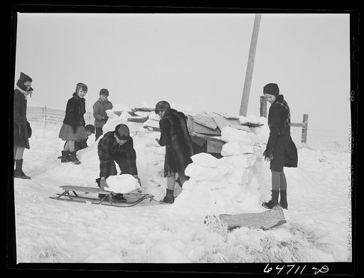 Morton County, North Dakota. Building snow fort at noon recess at a rural school