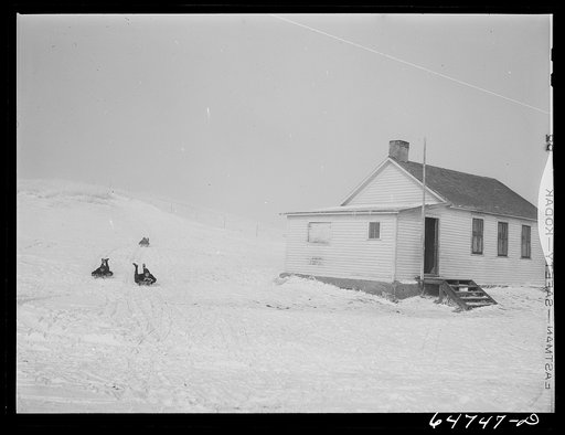 Morton County, North Dakota. Sliding down the hill at noon recess at a rural school