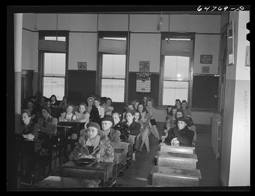 Epping, North Dakota. Meeting in the high school to promote the sale of defense stamps and bonds. High school girls are at the back of the room