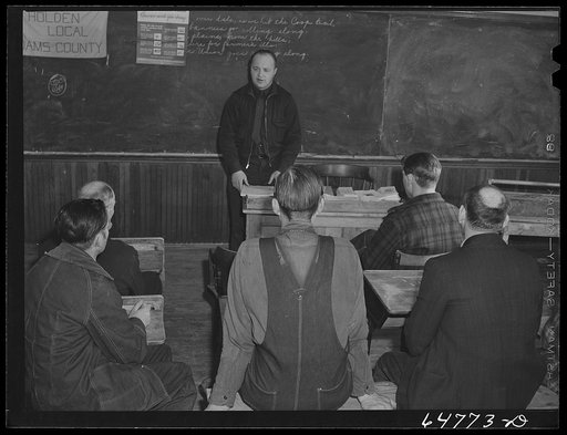 Adams County, North Dakota. County agent addressing farmers Food for Victory meeting in a rural schoolhouse