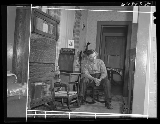 Adams County, North Dakota. North Dakota stock farmer, George P. Moeller, listening to war news on the radio