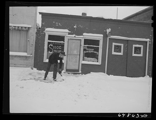 Untitled photo, possibly related to: Hettinger, North Dakota. A.H. Rosling, twenty-eight year old shoe repairman has been drafted and sold his shoe shop