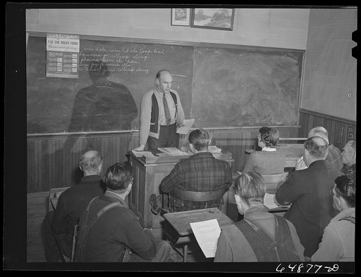 Adams County, North Dakota. FSA (Farm Security Administration) county supervisor Glenn Emch addressing farmers' Food for Victory meeting in a local schoolhouse