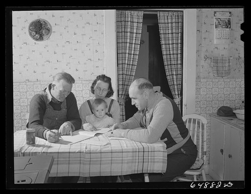 Adams County, North Dakota. FSA (Farm Security Administration) borrower Tom Endberg and county supervisor Glenn Emch going over account books