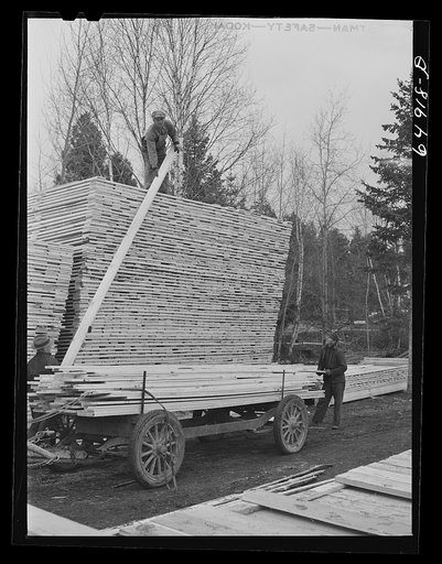 Untitled photo, possibly related to: Flathead Valley special area project, Montana. Stacking board lumber at the cooperative sawmill. This mill is operated by FSA (Farm Security Administration) borrowers, most of whom have moved to Flathead County in recent years from the drought area of eastern Mon