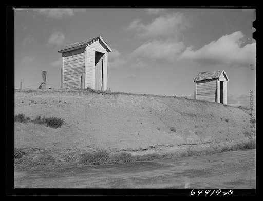 McCone County, Montana. Rural school privies on the edge of the new road cut