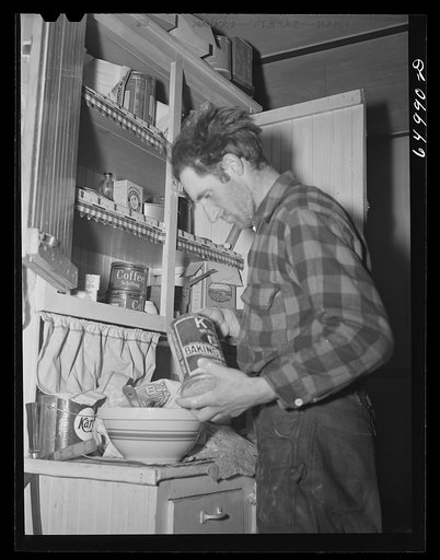 Garfield County, Montana. Sheepherder making biscuits in his winter quarters