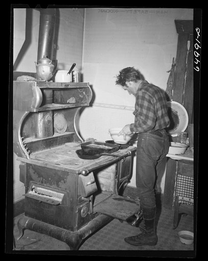 "[Untitled photo, possibly related to:  Garfield County, Montana. Sheepherder making biscuits in his winter quarters]"