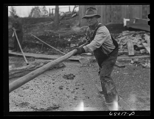 Untitled photo, possibly related to: Kalispell, Montana. Rolling logs into the pond at FSA (Farm Security Administration) cooperative sawmill