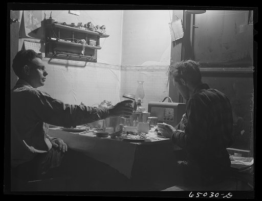Untitled photo, possibly related to:  Garfield County, Montana. Sheepherder eating in his winter quarters