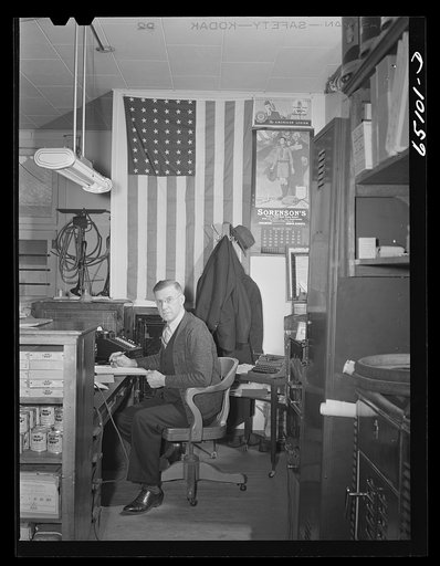 Williston, North Dakota. Mr. Dahlen hardware merchant, in his store. He is the county chairman for the defense saving campaign