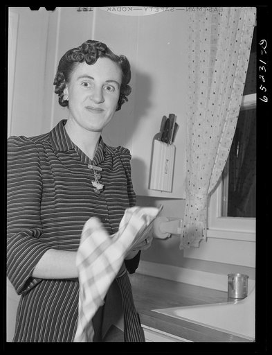 Untitled photo, possibly related to: Kalispell, Montana. Flathead valley speical area project, Mrs. Howard Harper drying dishes