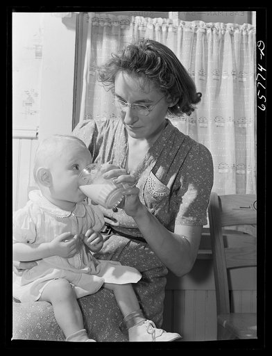 Lancaster County, Nebraska. Mrs. Pierce giving her daughter a glass of milk