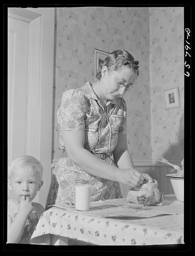 Lancaster County, Nebraska. Mrs. Lynn May, FSA (Farm Security Administration) borrower, cleaning a chicken