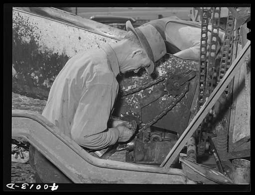 Repairing combine, getting ready for harvest. Genesee, Latah County, Idaho