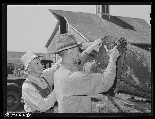 Repairing combine, getting ready for harvest. Genesee, Latah County, Idaho