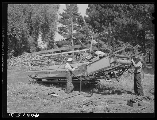 Repairing combine, getting ready for harvest. Genesee, Latah County, Idaho