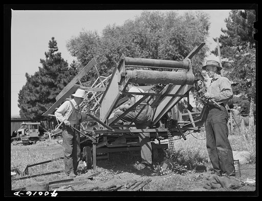 Repairing combine, getting ready for harvest. Genesee, Latah County, Idaho