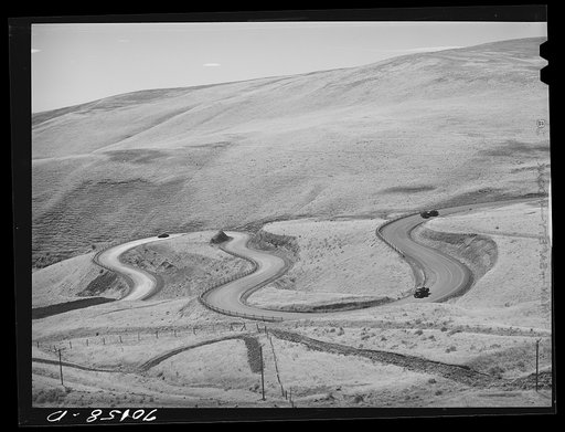Untitled photo, possibly related to: Highway leading down to the gorge at the Columbia River from the bench land. Klickitat County, Washington