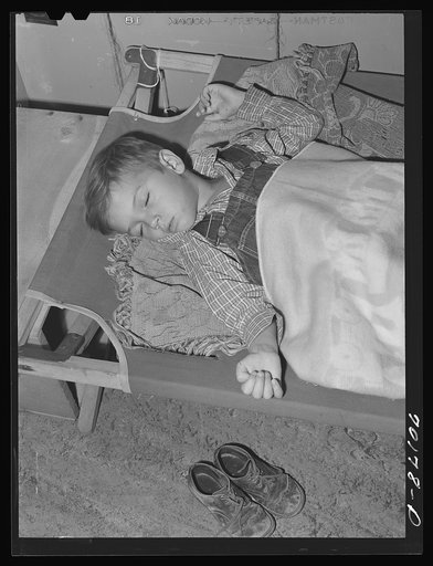 Child of farm worker takes a nap at the nursery school at the FSA (Farm Security Administration) farm family migratory labor camp. Yakima, Washington