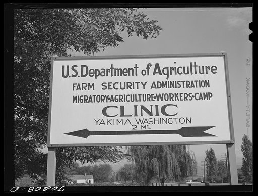 Sign, Yakima County, Washington. The clinic at FSA (Farm Security Administration) Labor Camps is a big drawing card