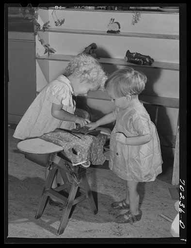Little girls play at the nursery school at the FSA (Farm Security Administration) farm family migratory labor camp. Yakima, Washington