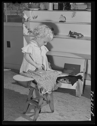 Little girl playing at the nursery school at the FSA (Farm Security Administration) farm family migratory labor camp. Yakima, Washington