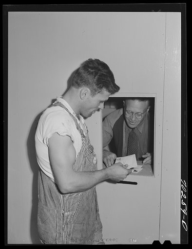 Farm worker getting mail at the FSA (Farm Security Administration) farm family migratory labor camp. Yakima, Washington. At this camp the post office was combined with the Washington State employment service office and in this way the state employment representative kept close check on how much work