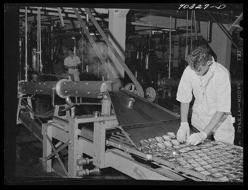 Canned tuna coming from sterlizing compartment. It will next be cooked for an hour. Columbia River Packing Association, Astoria, Oregon