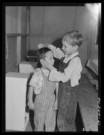 Lunch at the nursery school at the FSA (Farm Security Administration) mobile camp for migratory farm workers. Odell, Oregon. The older girl, member of the Junior Campers League, receives credits for helping in the nursery school