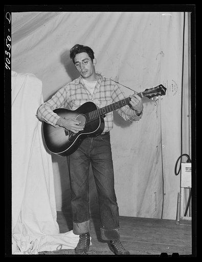 Singing cowboy songs at entertainment at the FSA (Farm Security Administration) mobile camp for migratory farm workers. Odell, Oregon