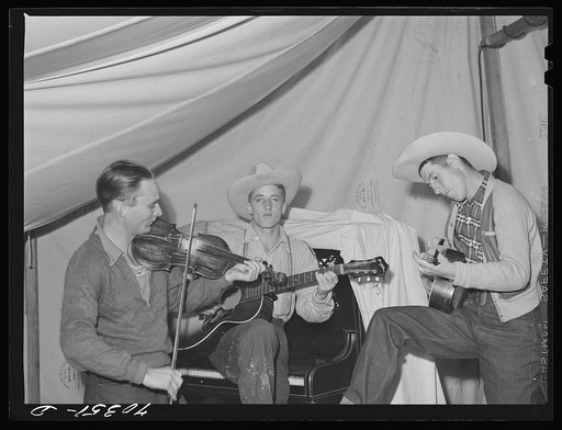 Singing cowboy songs at entertainment at the FSA (Farm Security Administration) mobile camp for migratory farm workers. Odell, Oregon