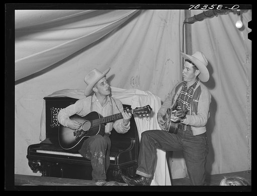 Singing cowboy songs at entertainment at the FSA (Farm Security Administration) mobile camp for migratory farm workers. Odell, Oregon