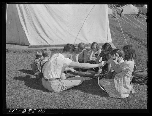 Repairing bicycle. FSA (Farm Security Administration) mobile camp for migratory farm workers. Odell, Oregon