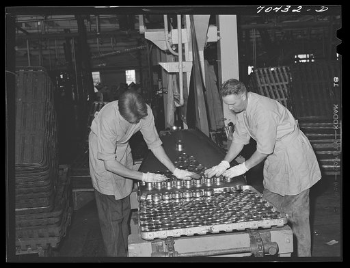Putting cans of salmon in trays before placing in ovens, where they will be cooked one and a half hours. Columbia River Packing Association, Astoria, Oregon