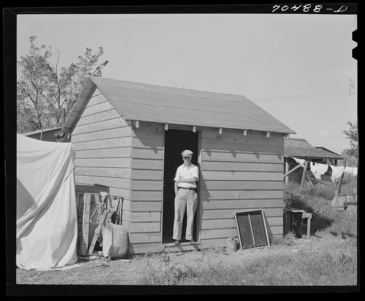 This workman at the Umatilla ordnance depot built this house for his family, spending fifty dollars for materials. He rents building space from homeowner in Hermiston, Oregon. He pays for use of sanitary facilities in house of homeowner; outside privies are provided
