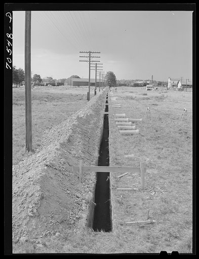 Ditch for sewer pipe at the FSA (Farm Security Administration) trailer camp for workmen at the Umatilla ordnance depot. Hermiston, Oregon