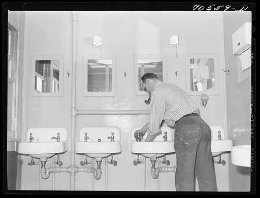 Workman at Navy shipyards, Bremerton, Washington, in the washroom at the FSA (Farm Security Administration) dormitories