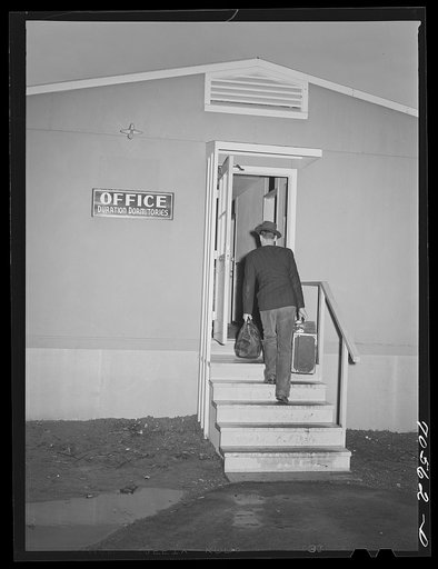 Workman at the Navy shipywards arrives at the FSA (Farm Security Administration) duration dormitory looking for a room. Bremerton, Washington