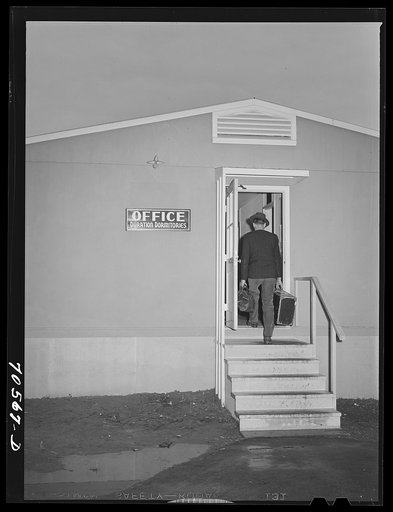 Untitled photo, possibly related to: Workman at the Navy shipywards arrives at the FSA (Farm Security Administration) duration dormitory looking for a room. Bremerton, Washington