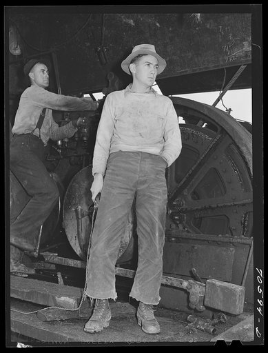Long Bell Lumber Company, Cowlitz County, Washington. Whistle punk on a donkey engine. He gives signals for yarding logs by means of the electrical button in his right hand