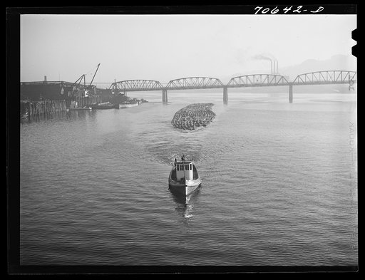 Untitled photo, possibly related to: Log rafts are towed by tugs in the Willamette River. Portland, Oregon