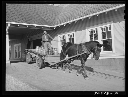 Dairy farmer takes home his empty milk cans from the Tillamook cheese plant. Tillamook, Oregon