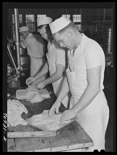 Arranging cheese cloth to be used in baby loaf cheeses. Tillamook cheese plant, Tillamook, Oregon